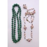 A string of antique Venetian beads and a string of malachite beads.