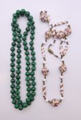 A string of antique Venetian beads and a string of malachite beads.