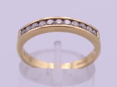 An 18 ct gold and diamond ring. Ring size P. 3.1 grammes total weight.