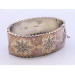An Edwardian silver star pattern bracelet. 7 cm wide.