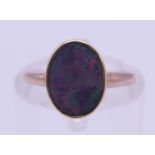 A 9 ct gold black opal ring. Ring size G.