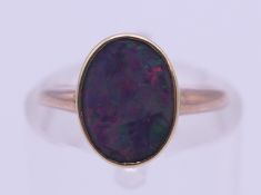 A 9 ct gold black opal ring. Ring size G.