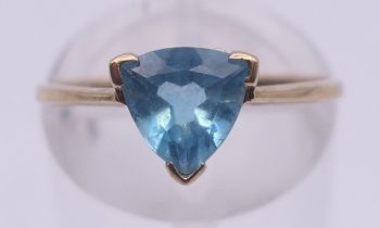 A 9 ct gold blue stone ring. Ring size M/N.