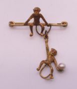 A seed pearl set monkey form brooch. 3.5 cm wide.