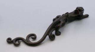 A bronze dragon scroll weight. 16 cm long.