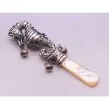 A silver and mother-of-pearl seahorse form rattle. 9.5 cm high.