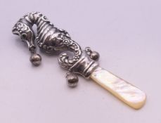 A silver and mother-of-pearl seahorse form rattle. 9.5 cm high.