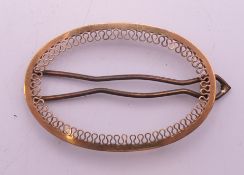 A 9 ct gold oval hair slide. 3.5 cm wide. 3.1 grammes total weight.