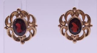 A pair of 9 ct gold and garnet earrings. 2 cm high.