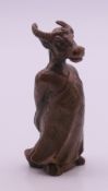 A bronze model of a bull in ceremonial costume. 7.5 cm high.