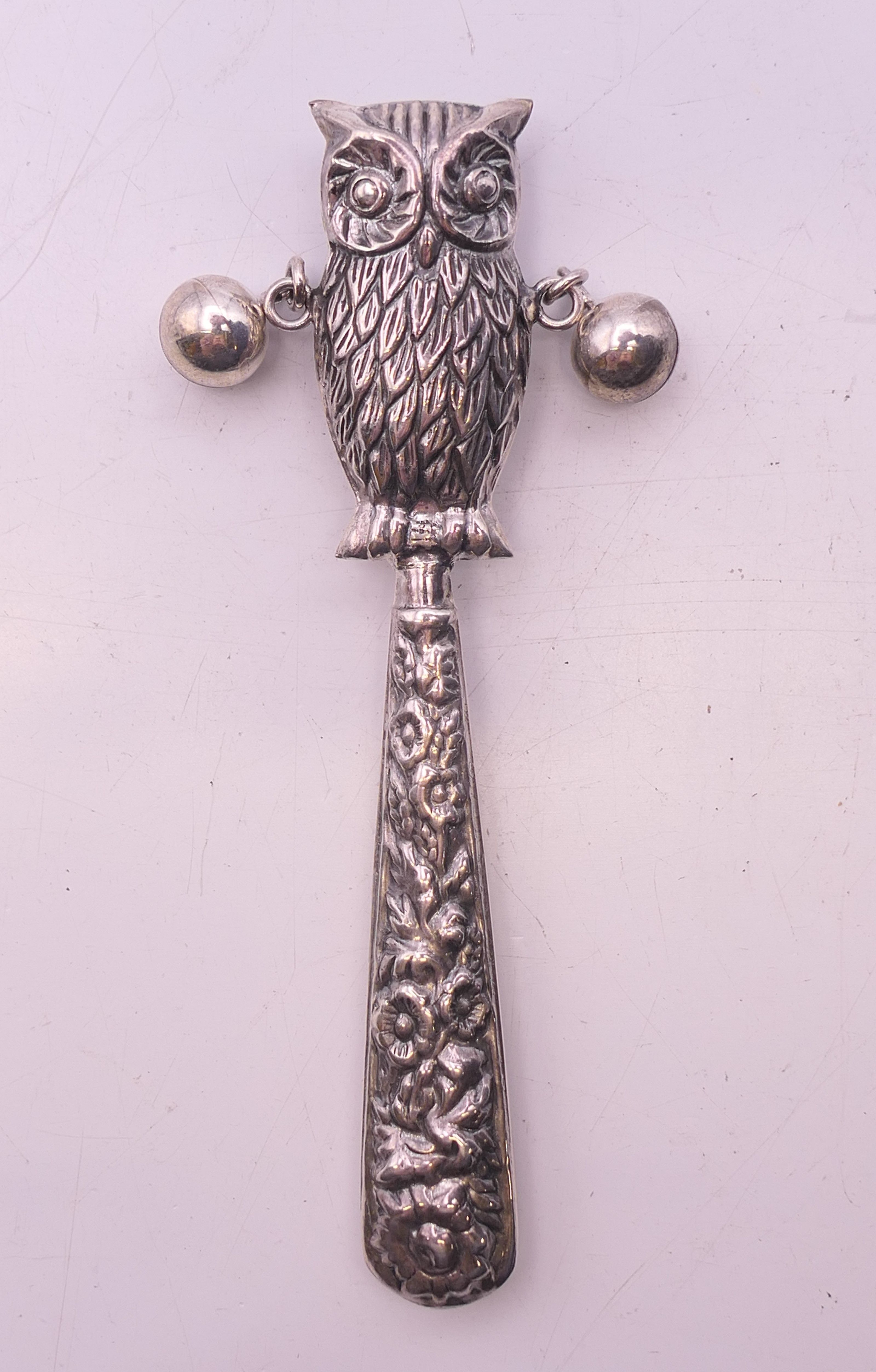 A silver owl form rattle. 8.5 cm high.
