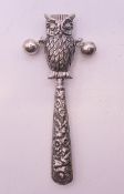 A silver owl form rattle. 8.5 cm high.