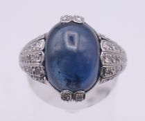 A platinum, sapphire and diamond ring, the central cabochon sapphire 4.5 ct.