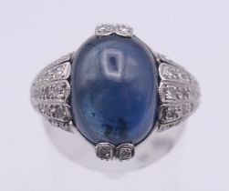 A platinum, sapphire and diamond ring, the central cabochon sapphire 4.5 ct.