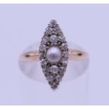 An 18 ct gold, pearl and diamond ring. Ring size J. 2.8 grammes total weight.
