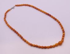 A string of butterscotch amber graduated beads. 64 cm long. 23.3 grammes total weight.