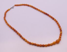A string of butterscotch amber graduated beads. 64 cm long. 23.3 grammes total weight.