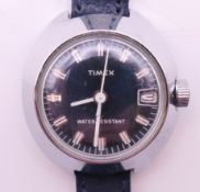 A Timex UFO blue dial with date aperture ladies wristwatch. 2.75 x 3 cm overall.