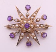 A 9 ct gold amethyst and seed pearl pendant/brooch. 4 cm wide. 8.3 grammes total weight.