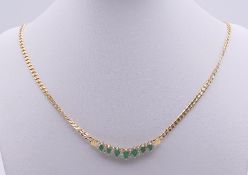 A 14 ct gold, diamond and emerald necklace. 45 cm long. 11.9 grammes total weight.