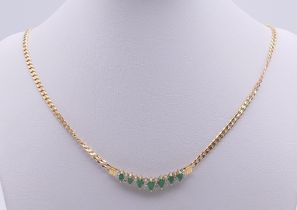A 14 ct gold, diamond and emerald necklace. 45 cm long. 11.9 grammes total weight.