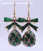 A pair of green enamel egg earrings. Bearing Russian marks. 2.75 cm high.