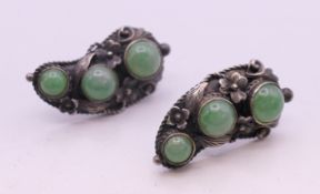 A pair of silver and jade earrings. 3 cm high.