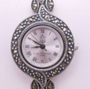 A Luke Stockley silver and marcasite ladies' wristwatch. 2.25 cm wide.