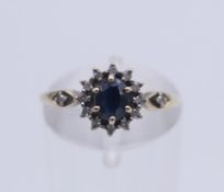 A 9 ct gold, sapphire and diamond ring. Ring size J/K.