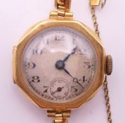 A 18 ct gold ladies' wristwatch. 2.5 cm wide. 17.9 grammes total weight.