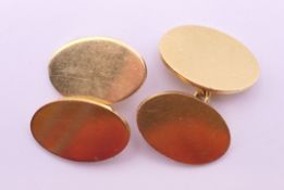A pair of 18 ct gold cufflinks. Each 1.8 cm high. 15 grammes.