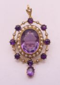 A 15 ct gold, amethyst and seed pearl pendant/brooch. 4.5 cm high. 6.5 grammes total weight.