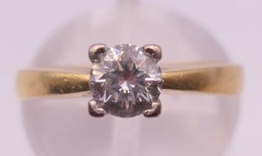 An 18 ct gold diamond solitaire ring,