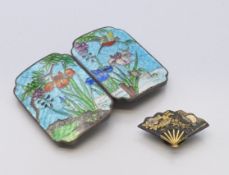 A Japanese Komai fan shaped lapel button badge circa 1900 and a cloisonne buckle decorated with