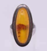A silver and amber ring. Ring size K.