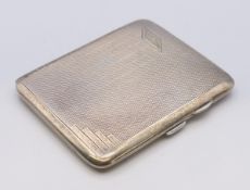 A silver Art Deco cigarette case. 8.5 x 7 cm. 70.7 grammes total weight.