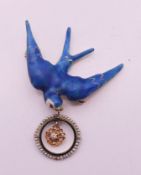 An unmarked gold and enamel swallow brooch. 3.5 cm wide. 6 grammes total weight.