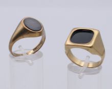 Two 9 ct gold gentlemen's signet rings. Square faced ring Q. 11.4 grammes total weight.