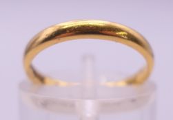 A 22 ct gold wedding band. Ring size I. 2.4 grammes.