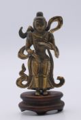 A small Chinese gilt metal deity on stand. 7.5 cm high including stand.