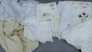 A quantity of linens to include a child's dress, a christening gown, embroidered,