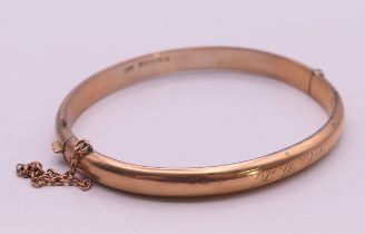 A 9 ct gold bangle bracelet. 6mm high, 6 cm internal diameter. 8 grammes.