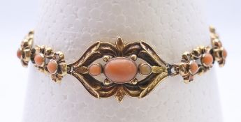 A 9 ct gold and coral bracelet. 18.5 cm long 10 grammes total weight.