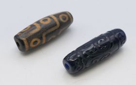 Two agate dzi beads. each 4 cm long.