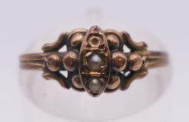 A seed pearl and unmarked gold ring. Ring size K/L.