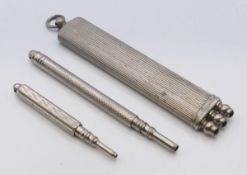 Two propelling pencils and a cased set of three propelling pencils.