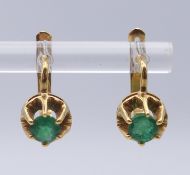 A pair of 18 ct gold and emerald-set earrings. 0.75 cm diameter. 4.2 grammes total weight.