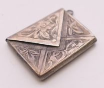 A silver envelope form stamp box. 3 x 2.25 cm.