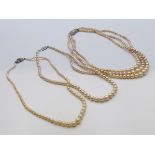 Three single strand pearl necklaces and one three strand pearl necklace.