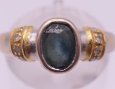 An 18 K white gold, diamond and sapphire ring. Ring size M/N. 4.9 grammes total weight.